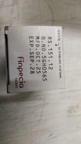 Box of Finpecia tablets, white packaging with red 'Finpecia' logo and printed batch/price text on the side.